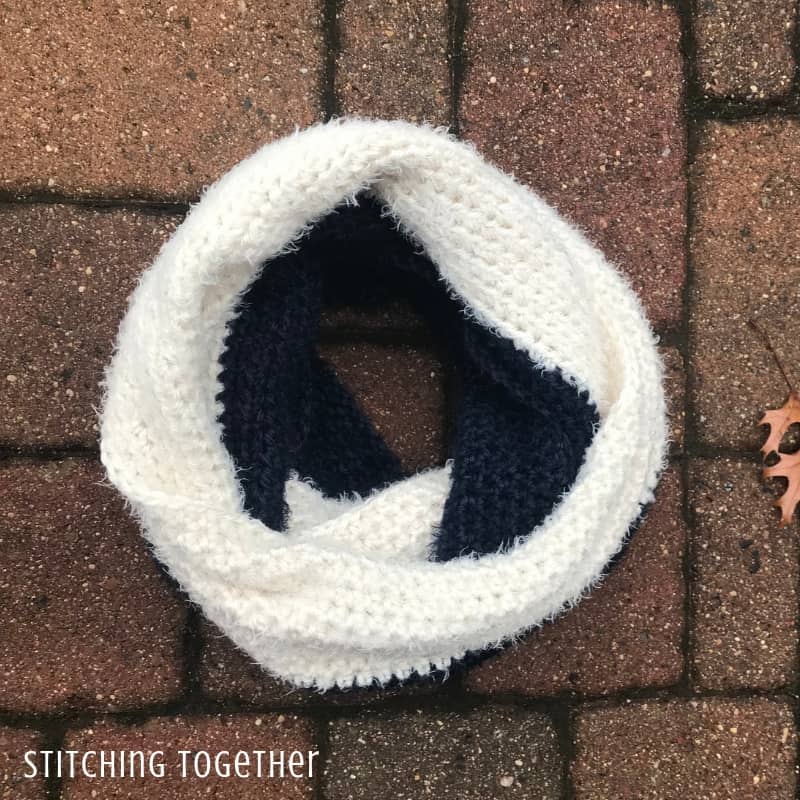 blue and white luxury crochet infinity scarf on the ground
