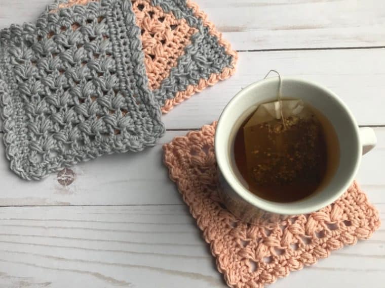 four crochet square coasters and a cup of tea
