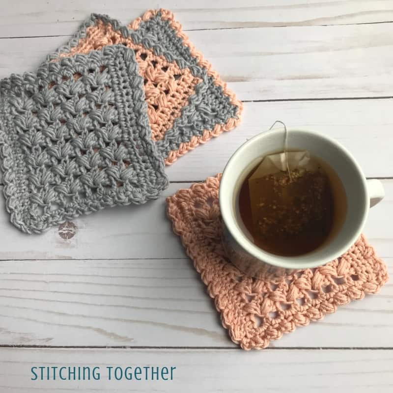 four crochet square coasters and a cup of tea