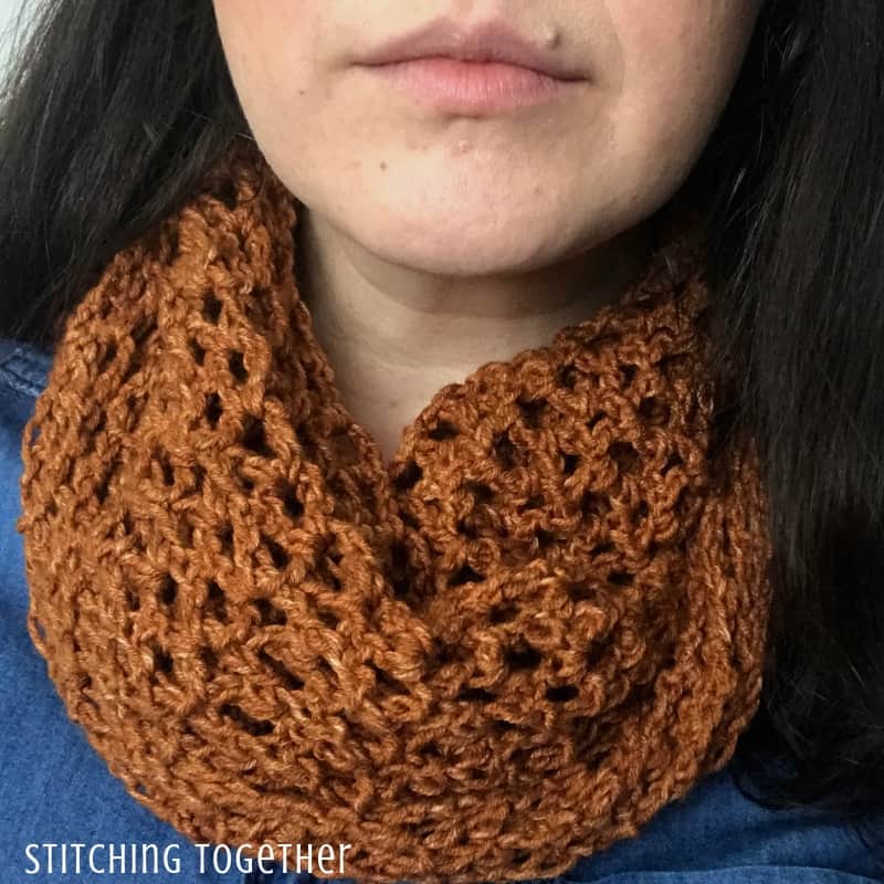 Lady wearing a copper colored lacy crochet scarf