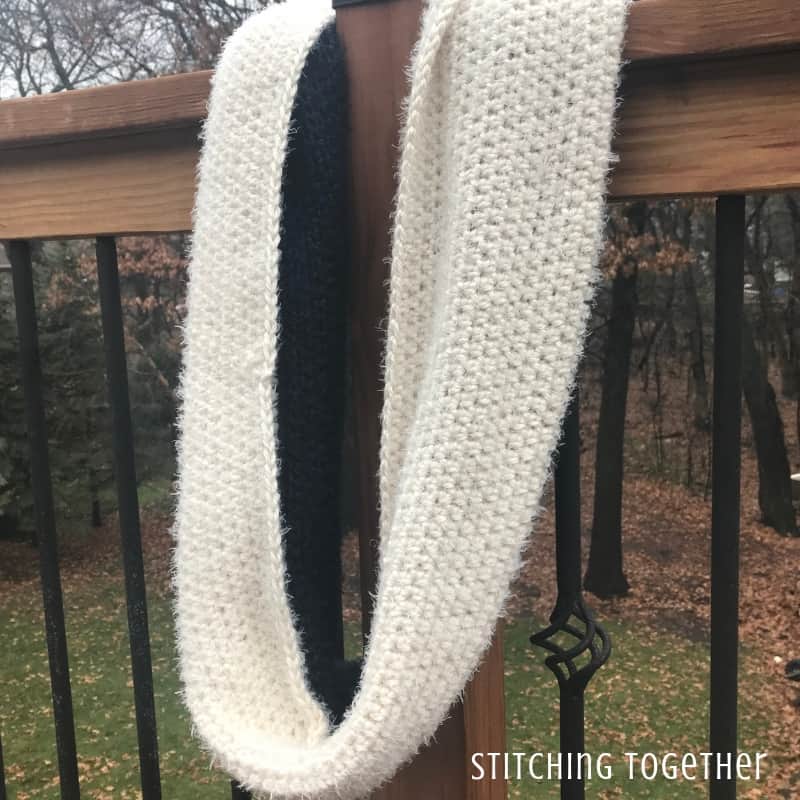 blue and ivory fluffy crochet infinity scarf hanging