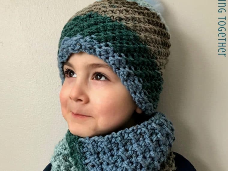 kid wearing blue and brown crochet hat and scarf