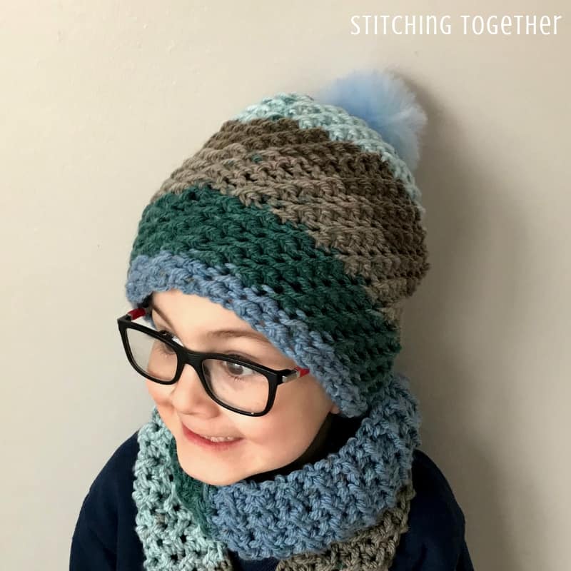 crochet hat and crochet boy scarf being worn by boy with glasses