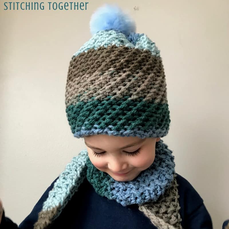 crochet hat with the crunch stitch and blue pom pom