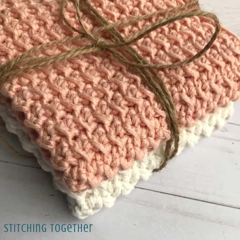 close up of two folded crochet washcloths