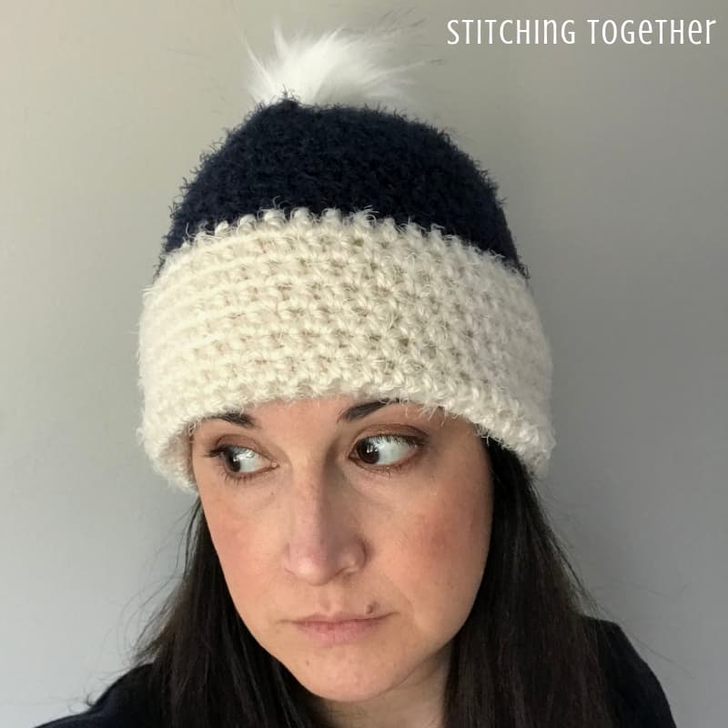 lady wearing off white and blue hdc beanie