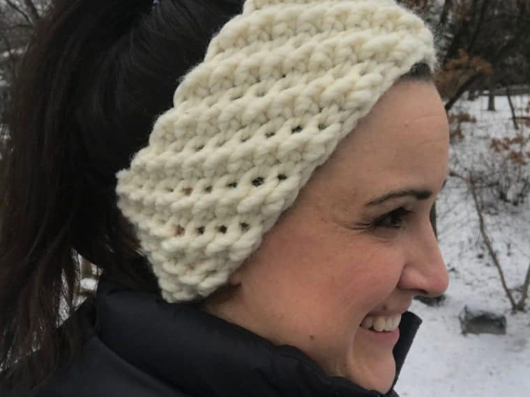 lady wearing a off white crochet winter headband