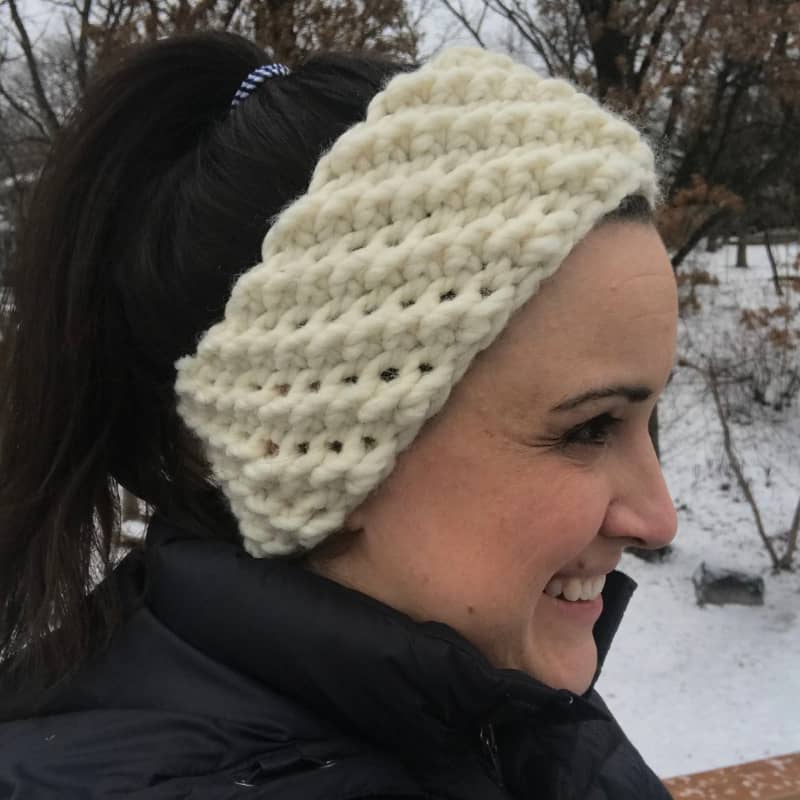 lady wearing a off white crochet winter headband