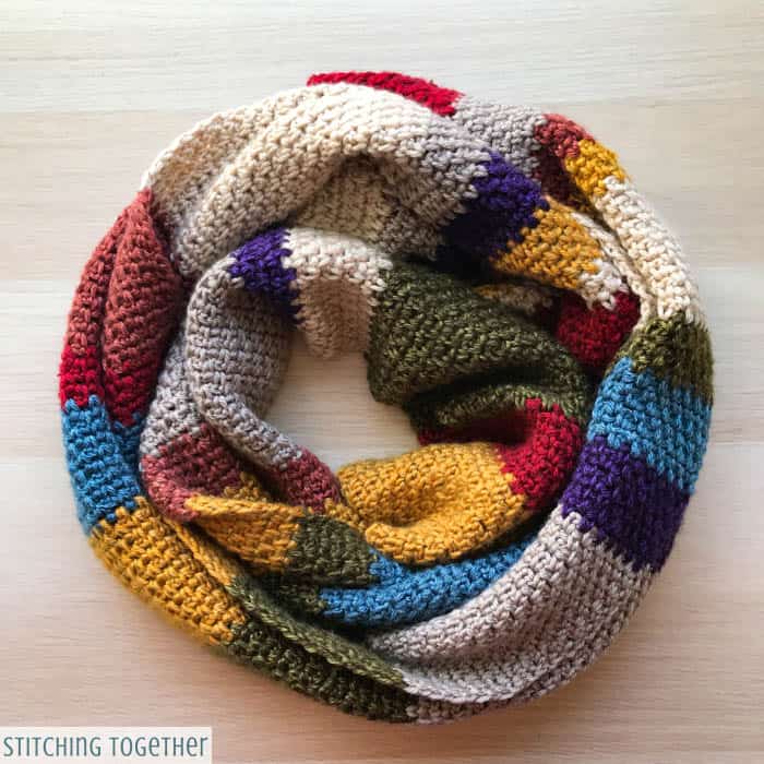 multicolored crochet scarf wrapped on ground