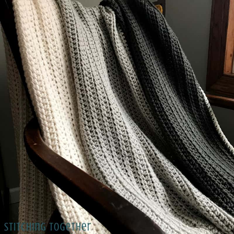 half double crochet throw blanket draped on chair