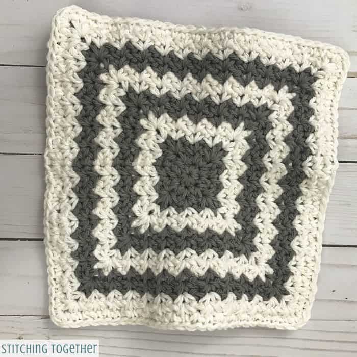 gray and white crochet trivet hot pad before blocking