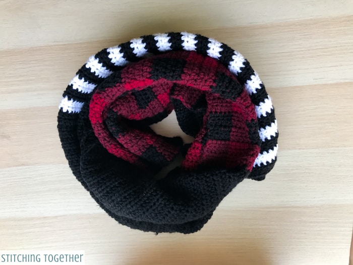buffalo plaid and striped crochet scarf rolled up
