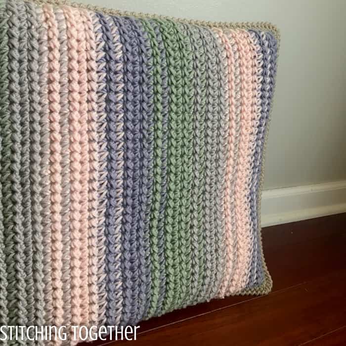 side view of crochet pillow cover that looks braided 