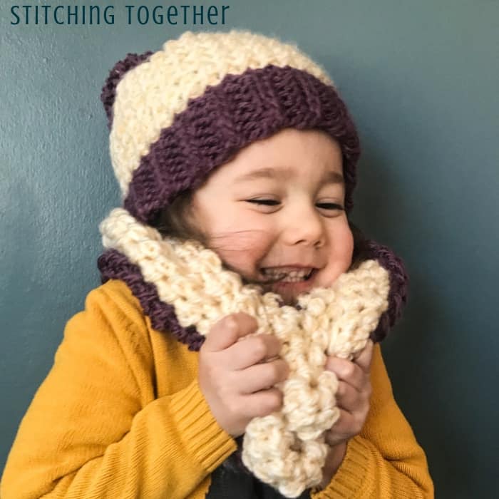 girl wearing matching crochet hat and scarf