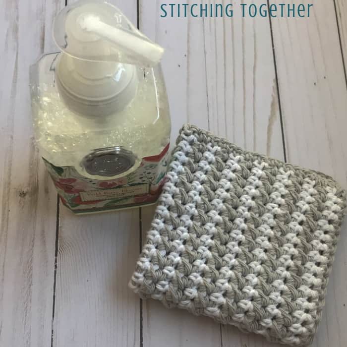 striped crochet dishcloth with a bottle of hand soap
