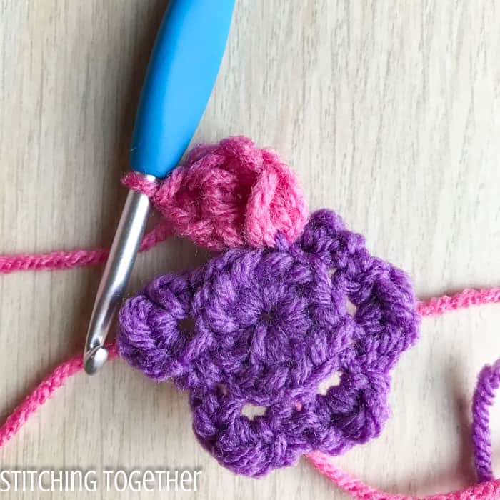 adding crochet petals to a flower