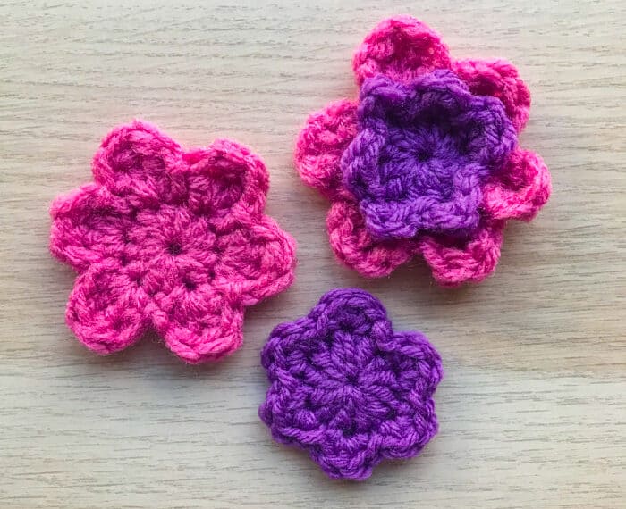 pink and purple crochet flowers on with double petals