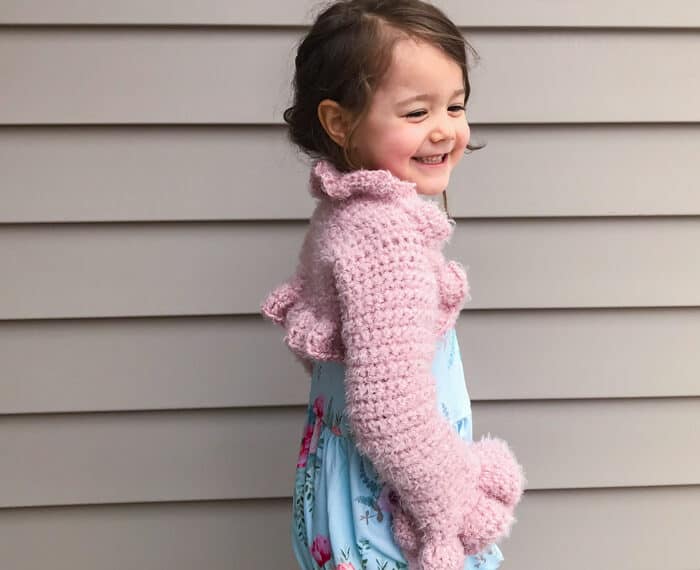 girl wearing pink crochet bolero with ruffles
