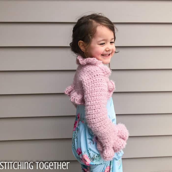 girl wearing pink crochet bolero with ruffles