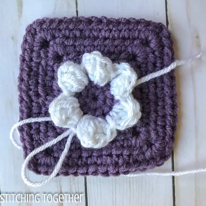 in process solid square with white flower