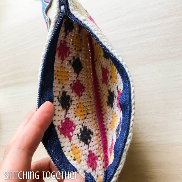 open crochet pouch with a zipper showing the inside