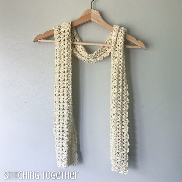thin crochet scarf draped on a hanger