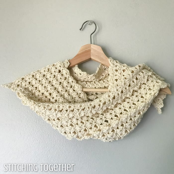 crochet lacy scarf wrapped on a hanger