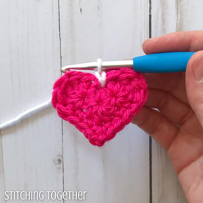 adding a white round to a pink crochet heart