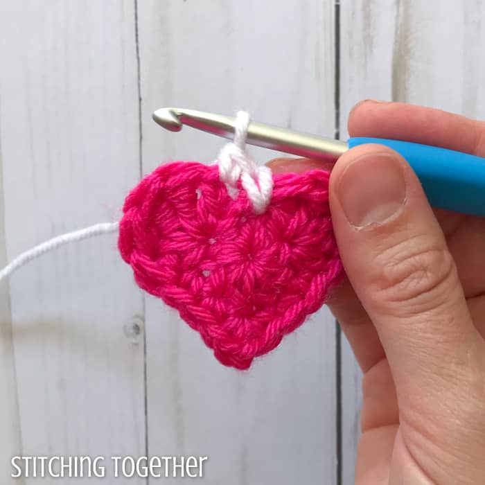 adding a white round to a pink crochet heart