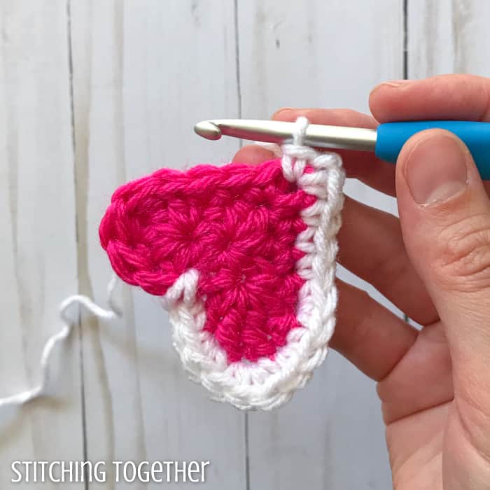 adding a white round to a pink crochet heart