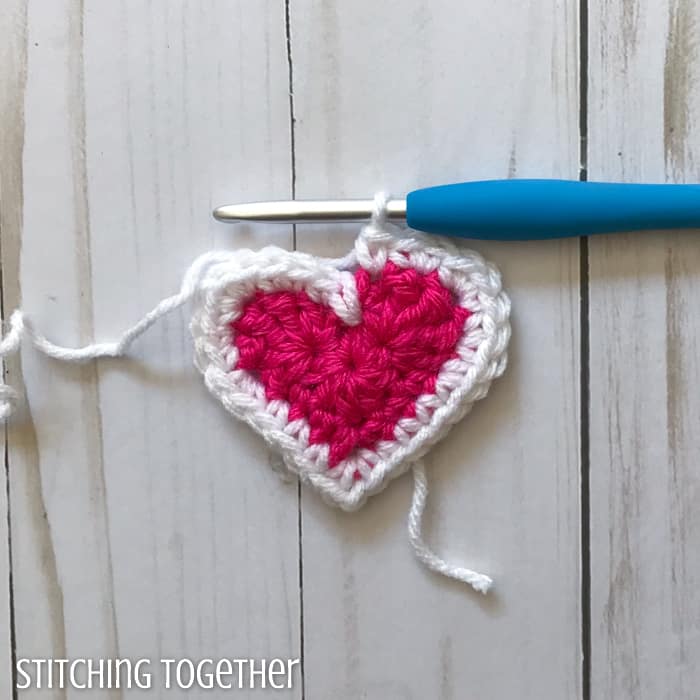 adding a white round to a pink crochet heart