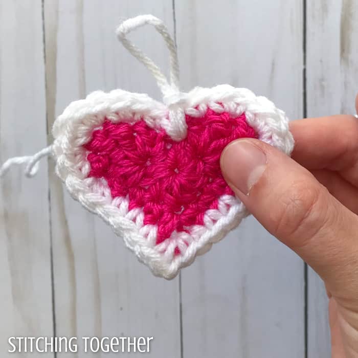 adding a white round to a pink crochet heart