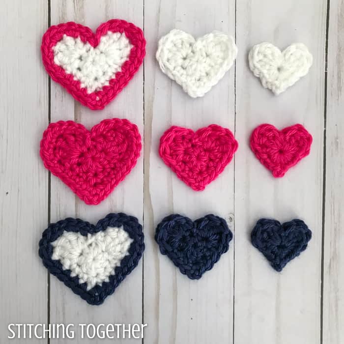 pink, blue and white crochet hearts lined up