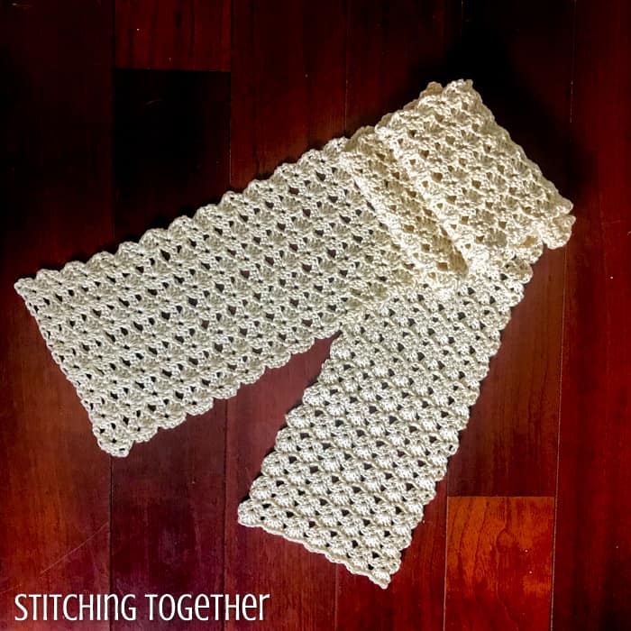 ivory colored lacy crochet scarf folded