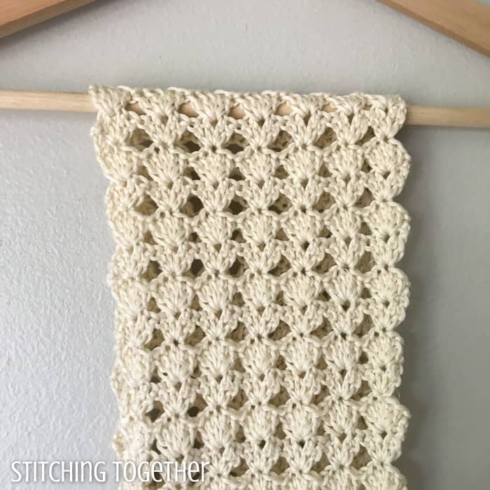 lace crochet scarf draped over a hanger