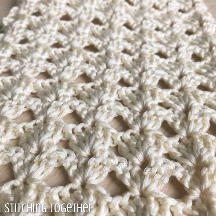 close up of crochet shell stitches done in ivory yarn