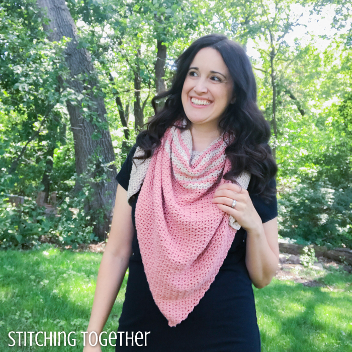 smiling woman wearing a crochet triangle scarf
