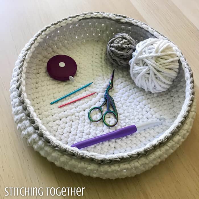 crochet tools and yarn in a round crochet bowl