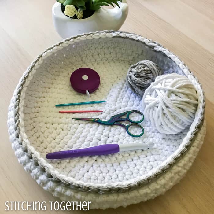 white crochet bowl with crochet tools inside