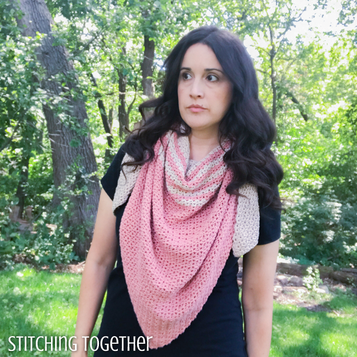 woman wearing a pink and tan striped crochet triangle scarf