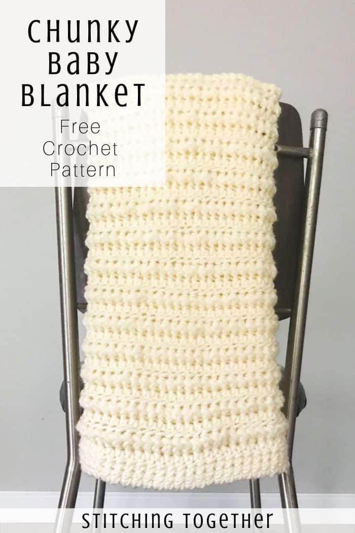 crochet baby blanket hanging on the back of the chair