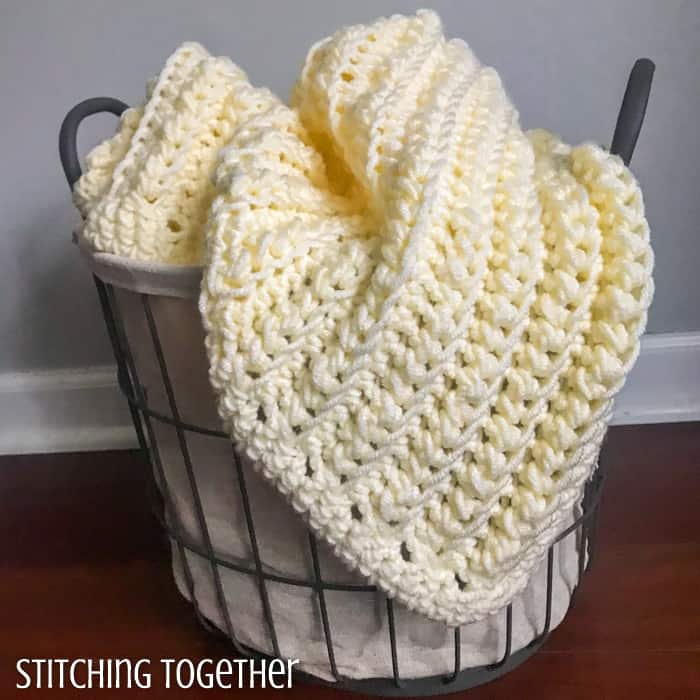 chunky crochet baby blanket in a basket