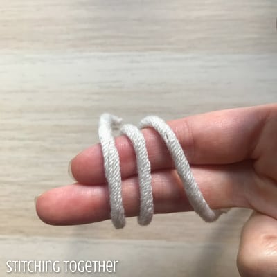 yarn wrapped around two fingers