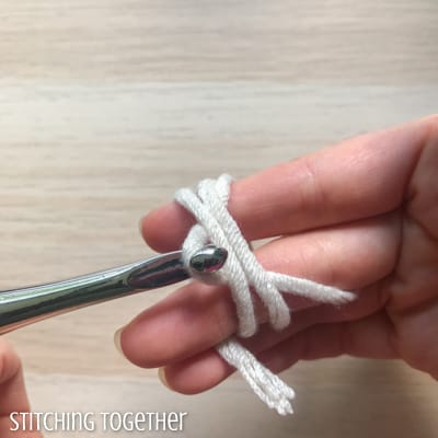 Hook and yarn wrapped around fingers
