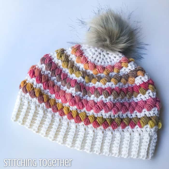 crochet women's hat with colorful puff stitches and pom pom