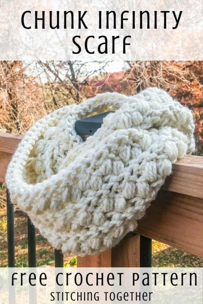 crochet chunky scarf wrapped on the post of a deck