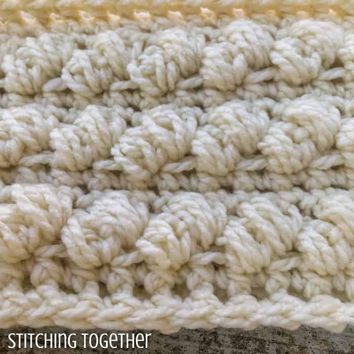 close up of crochet puff stitches in a chunky scarf