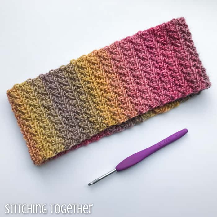 crochet ear warmer headband next to hook