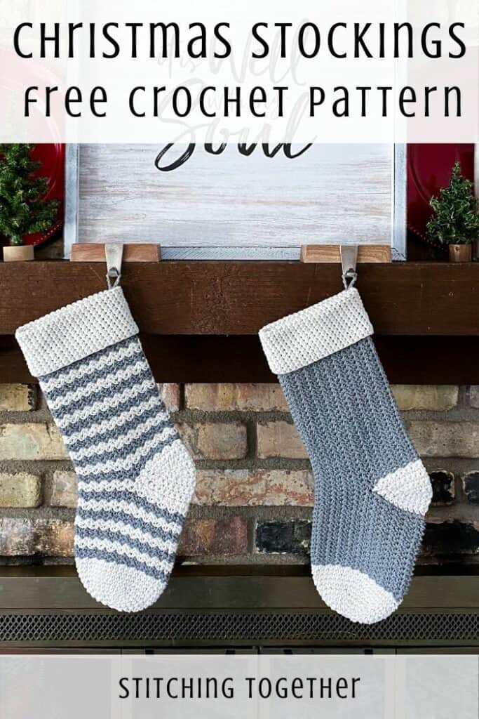 2 gray and white crochet stockings hanging on a mantle 