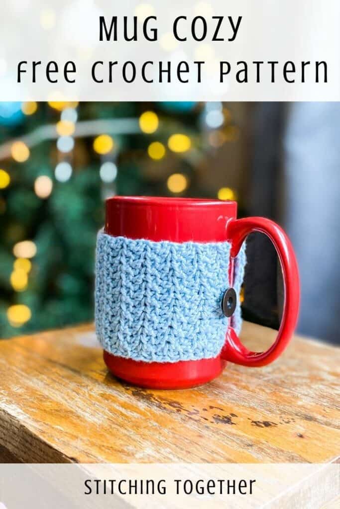 blue mug cozy on a red cup sitting on a table